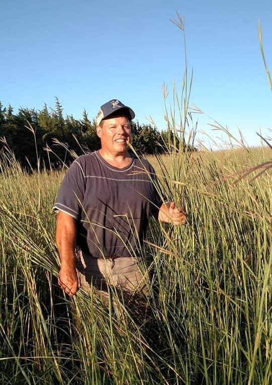 Kevin Fulton smiling and standing in a field.
