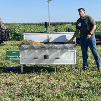 Jordan Uldrich presenting to a group about ways farming practices like reduced tillage, growing cover crops and grazing crop ground that can improve the health of the soil and save money.
